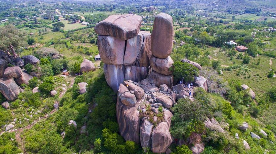 Tall rock formation with water trickling down its face near Ilesi