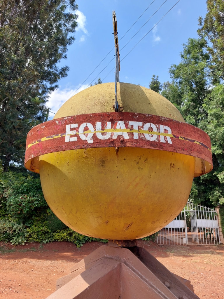 Equator marker sign beside a rural road in western Kenya